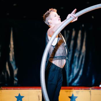 Male circus acrobat with a ring