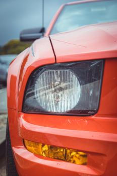 Red Ford Mustang headlight close-up