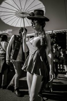 Woman with a hat holding an umbrella at Newtown festival 2021