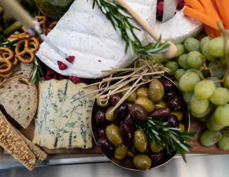 Cheese platter with olives and grapes