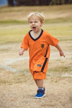 Blonde little boy in Netherland kit yelling at Little Dribblers sports contest