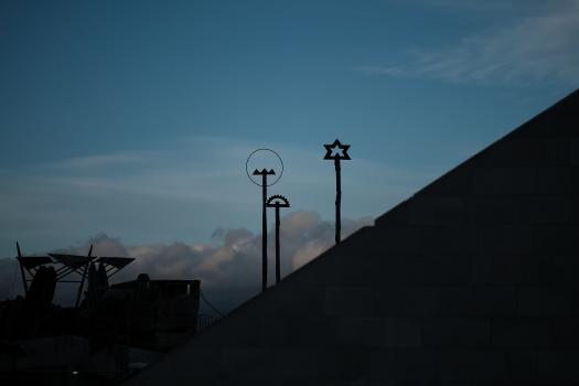 Silhouette of signs on poles