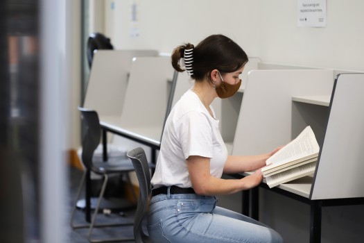Girl in blue jeans reading a book