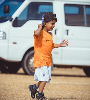 Boy wearing backwards cap and Nike Netherland kit - Little Dribblers