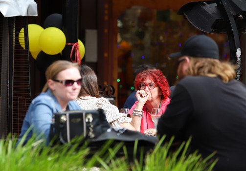 Woman with red hair and glasses at a cafe