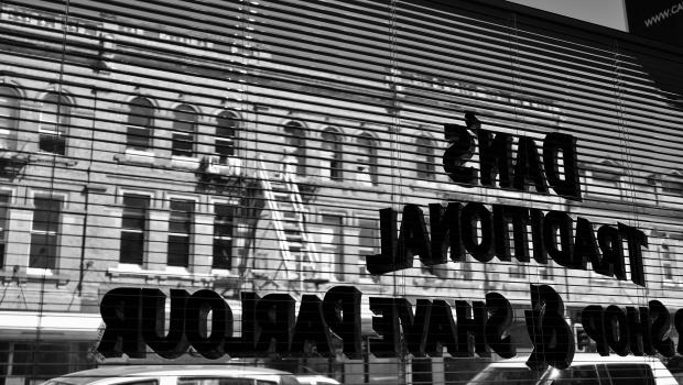 Dan's barber shop and shave parlour inverted sign at K' road black and white