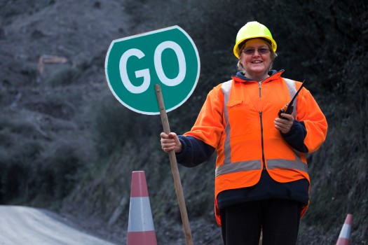 Lady with green GO traffic sign