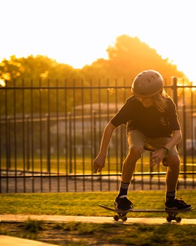 Young Boy Skate Boarding Golden Hour