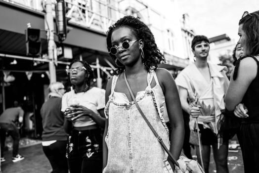 Black girl in sunglasses and dungarees