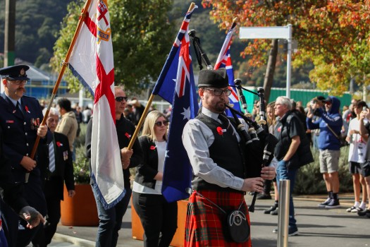 Bagpipe performer leading parade, ANZAC 22
