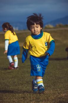 Little boy wearing Brasil kit at Little Dribblers soccer match
