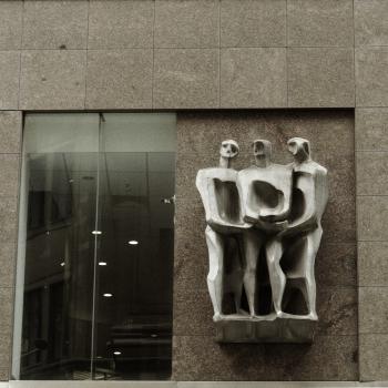 Sculpture holding hands on wall in Sydney
