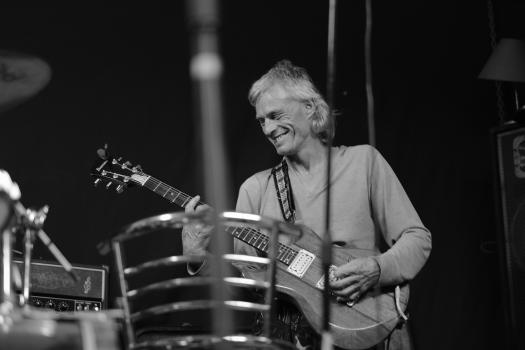 Guitarist for band "Vietnam" smiling monochrome