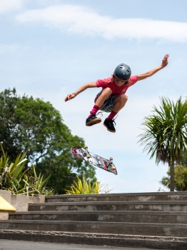 Boy Flipping Skateboard Air
