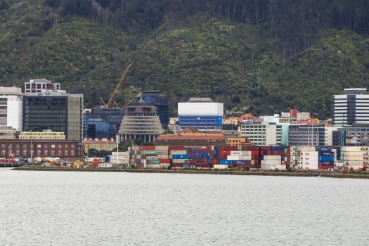 Sea, shipping containers, buildings and hills