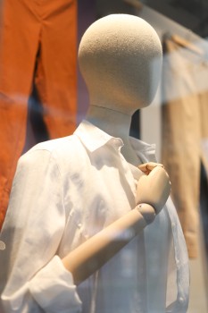 Mannequin displaying white shirt at a shop
