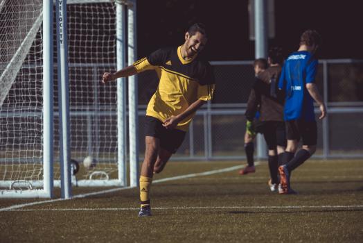 Football player in yellow Adidas shirt laughing - Sports Zone sunday league