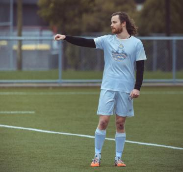 Player with long hair point to the ground - Sports Zone sunday league