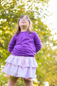 Girl with Down syndrome on tree background