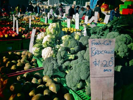 Brocolli cauliflower avocados and other produce at fruit & vegetable market