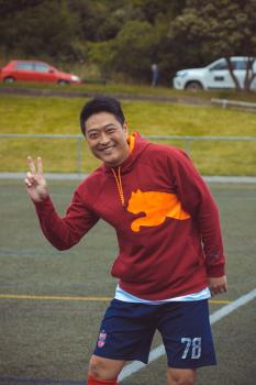 Athlete in red Puma hoodie orange logo - Sports Zone sunday league