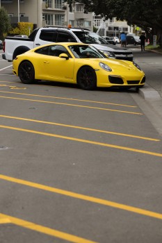 Yellow Porsche Carrera S parked in the street