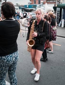 Woman playing saxophone on the street at Cuba Dupa 2021