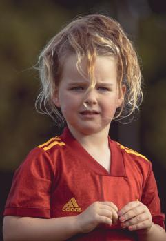 Girl in red shirt at Little Dribblers soccer match