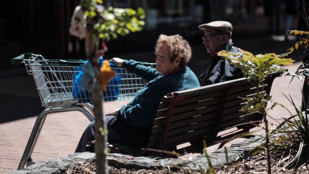 Old woman and man sitting on a bench