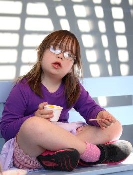Cute girl with Down syndrome eating ice cream