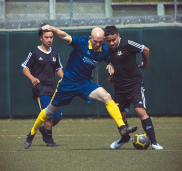 Bald player tackling opponent - Sports Zone sunday league