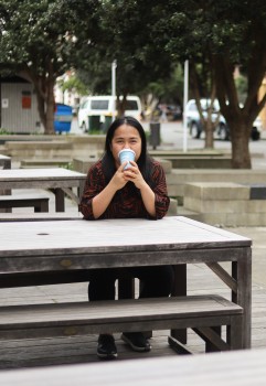 Woman drinking coffee outside