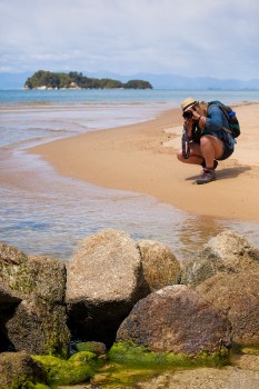 European tourist girl shoots photo on beach