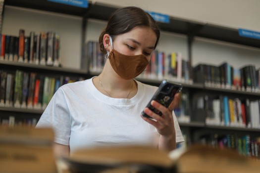 Girl wearing a mask looking at her phone