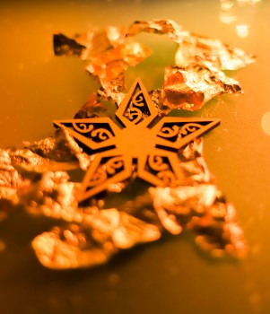 Matariki star wooden ornament on gold foil