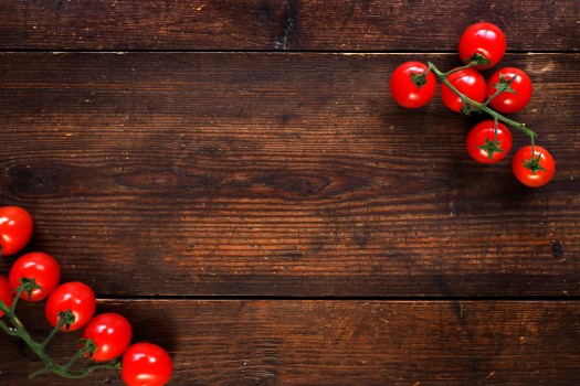 Red tomatoes on a wooden table top