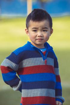 Boy in striped sweater at Little Dribblers soccer match