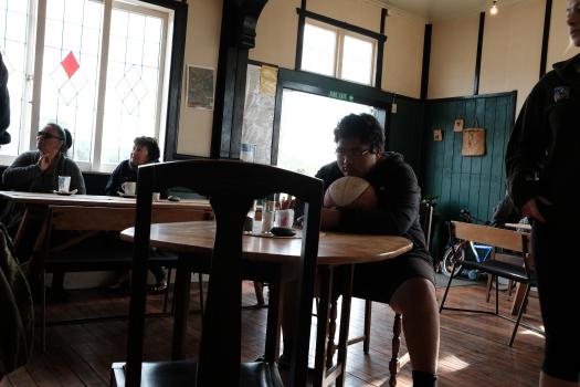 Boy resting chin on his basketball at a restaurant