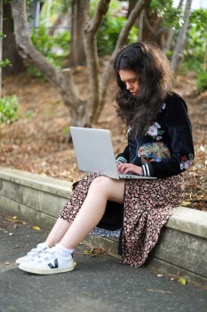 Young lady with WBS working on a laptop