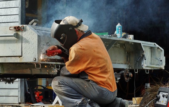 Man welding a trailer 
