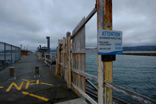 Wharf and an attention sign on a cloudy day