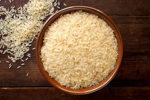 Bowl of rice on wooden background