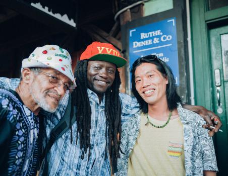Man with dreadlocks pose for a picture with his friends at Newtown festival 2021