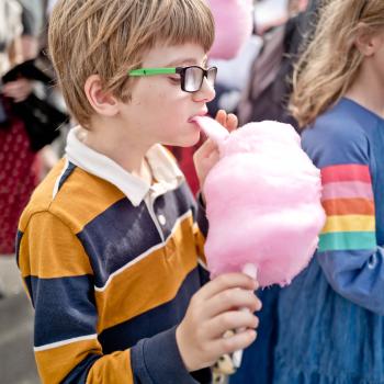 Nerdy kid eating pink cotton candy at Newtown festival 2021