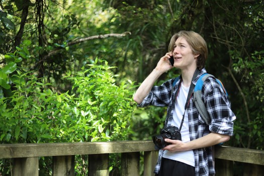 Photographer talking on cell phone in nature