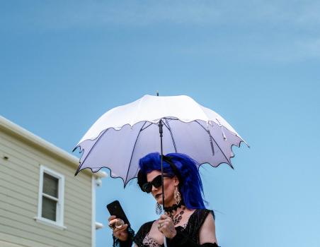 Woman with blue hair and white umbrella at Newtown Festival 2020