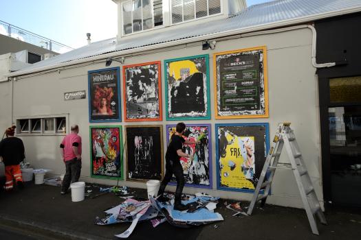 Posters being removed from a wall