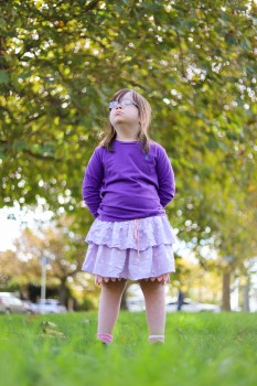 Child with Down syndrome in a cute outfit