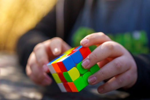 A young expert solves a Rubik's cube