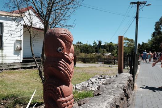 Maori sculpture on a rock at Whakarewarewa